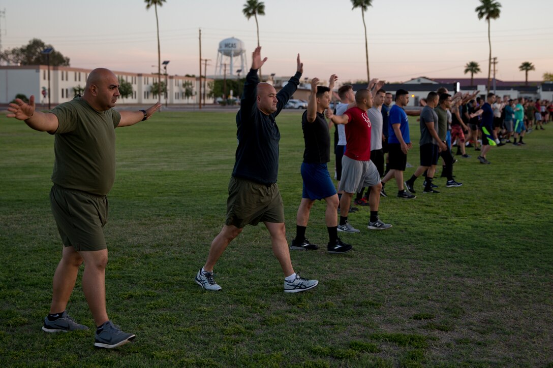 U.S. Marines Stationed at Marine Corps Air Station (MCAS) Yuma participate conduct warm up drills during High Intensity Tactical Training (HITT) on The Lawn at the parade deck on MCAS Yuma Ariz., April 26, 2019. HITT on the Lawn is a physical training event that is open to anyone with base access and provides them with a physical training opportunity. (U.S. Marine Corps photo by Lance Cpl. Joel Soriano)