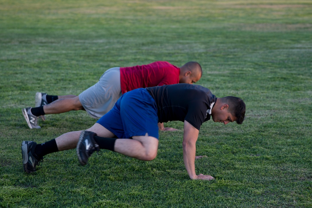 U.S. Marines Stationed at Marine Corps Air Station (MCAS) Yuma conduct "mountain climbers" during High Intensity Tactical Training (HITT) on The Lawn on the parade deck at MCAS Yuma Ariz., April 26, 2019. HITT on the Lawn is a physical training event that is open to anyone with base access and provides them with a physical training opportunity. (U.S. Marine Corps photo by Lance Cpl. Joel Soriano)