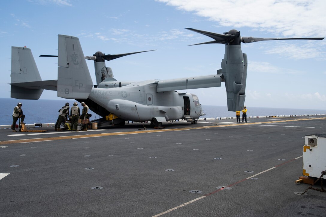 Marines and Sailors with the 31st Marine Expeditionary Unit and the amphibious assault ship USS Wasp (LHD 1) unload supplies from an MV-22B Osprey tiltrotor aircraft with Marine Medium Tiltrotor Squadron 265 (Reinforced) during flight operations underway in the Philippine Sea, June 4, 2019. The 31st Marine Expeditionary Unit, the Marine Corps’ only continuously forward-deployed MEU, provides a flexible and lethal force ready to perform a wide range of military operations as the premier crisis response force in the Indo-Pacific region. (Official U.S. Marine Corps photo by Lance Cpl. Brennan Priest)