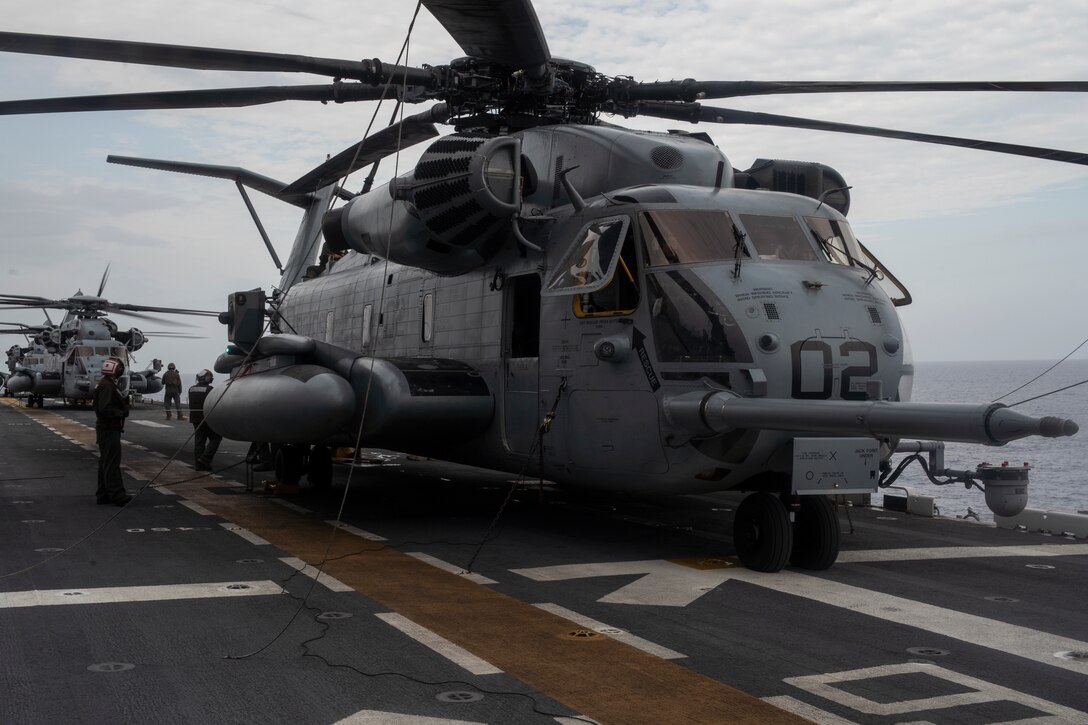 Flight-deck crewmembers secure A CH-53E Super Stallion with Marine Medium Tiltrotor Squadron 265 (reinforced) aboard the amphibious assault ship USS Wasp (LHD 1) during flight operations while underway in the Philippine Sea, June 4, 2019. The 31st Marine Expeditionary Unit, the Marine Corps’ only continuously forward-deployed MEU, provides a flexible and lethal force ready to perform a wide range of military operations as the premier crisis response force in the Indo-Pacific region. (Official U.S. Marine Corps photo by Lance Cpl. Brennan Priest)