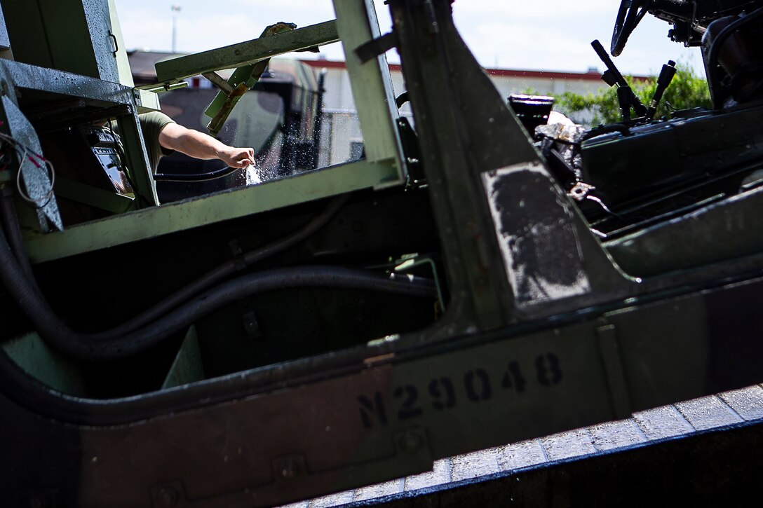 A Marine with the 31st Marine Expeditionary Unit sprays a tactical vehicle at Camp Hansen, Okinawa, Japan, May 21, 2019. The 31st MEU, the Marine Corps' only continuously forward-deployed MEU partnering with the U.S. Navy's Amphibious Squadron 11, provides a flexible and lethal force ready to perform a wide range of military operations as the premier crisis response force in the Indo-Pacific region. (U.S. Marine Corps photo by Gunnery Sgt. T. T. Parish/Released)