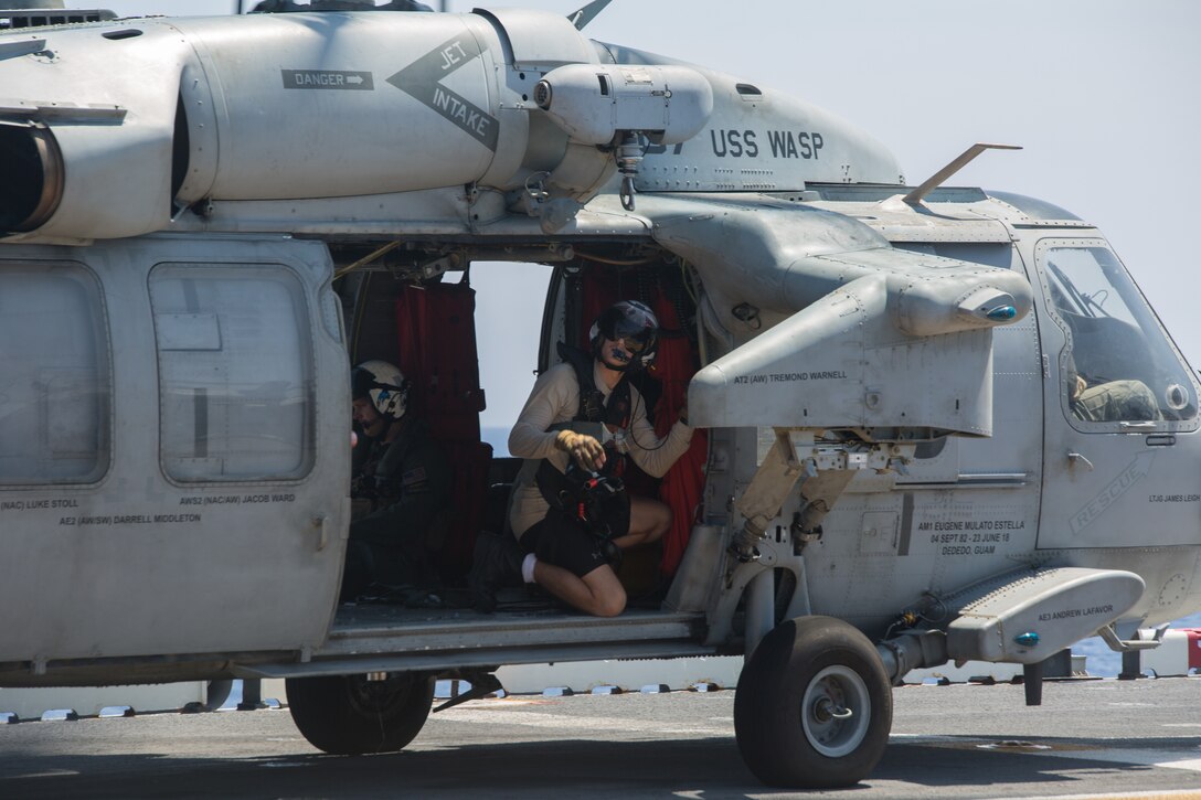 A Sailor sits in an MH-60S Seahawk during flight operations aboard the USS Wasp (LHD 1) while underway in the Philippine Sea, June 5, 2019. The 31st Marine Expeditionary Unit, the Marine Corps` only continuously forward-deployed MEU, provides a flexible and lethal force ready to perform a wide range of military operations as the premier crisis response force in the Indo-Pacific region. (Official U.S. Marine Corps photo by Lance Cpl. Kenny Nunez Bigay)
