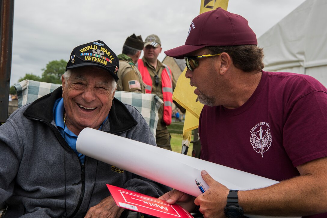 U.S. Army World War II and D-Day veteran, Vincent Speranza, 501st Parachute Infantry Regiment, 101st Airborne Division paratrooper smiles mid-conversation during the D-Day 75 Commemorative Airborne Operation outside Sainte-Mère-Église, France, June 9, 2019. Speranza fought in the Battle of the Bulge between 1944 and 1945, a battle that would result in the highest casualties of any operation during WWII. Speranza believes in the importance of sharing his story, his piece of history, with others because as he says, and Winston Churchill has similarly said, “Those who are not willing to learn history are doomed to repeat it.” (U.S. Air Force photo by Senior Airman Kristof J. Rixmann)