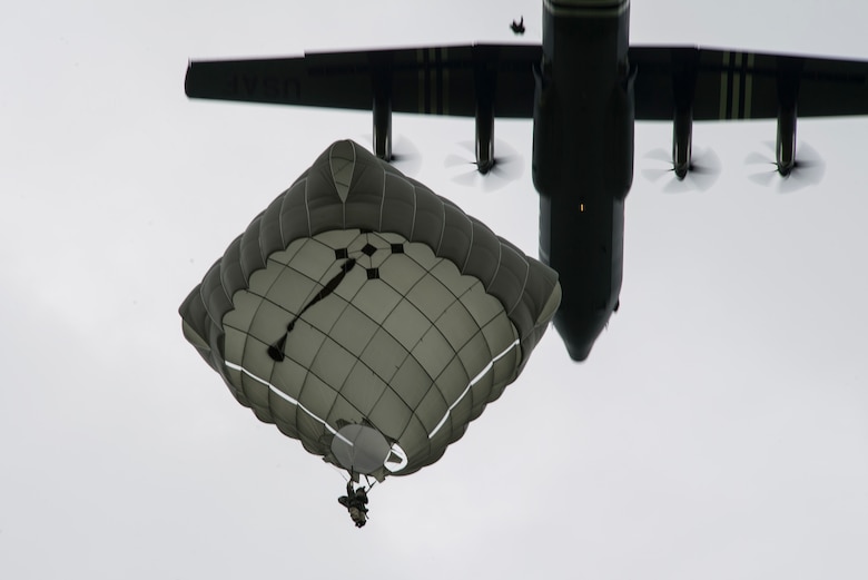 A static-line paratrooper prepares to land as a U.S. Air Force C-130J Super Hercules, assigned to the 37th Airlift Squadron, Ramstein Air Base, Germany, passed overhead during the D-Day Commemorative Airborne Operation over Iron Mike Drop Zone, outside Saint-Mere-Eglise, France June 9, 2019. Approximately 23 aircraft dropped over one thousand personnel in honor of the airborne operation held on June 6, 1944. (U.S. Air Force photo by Senior Airman Devin M. Rumbaugh)