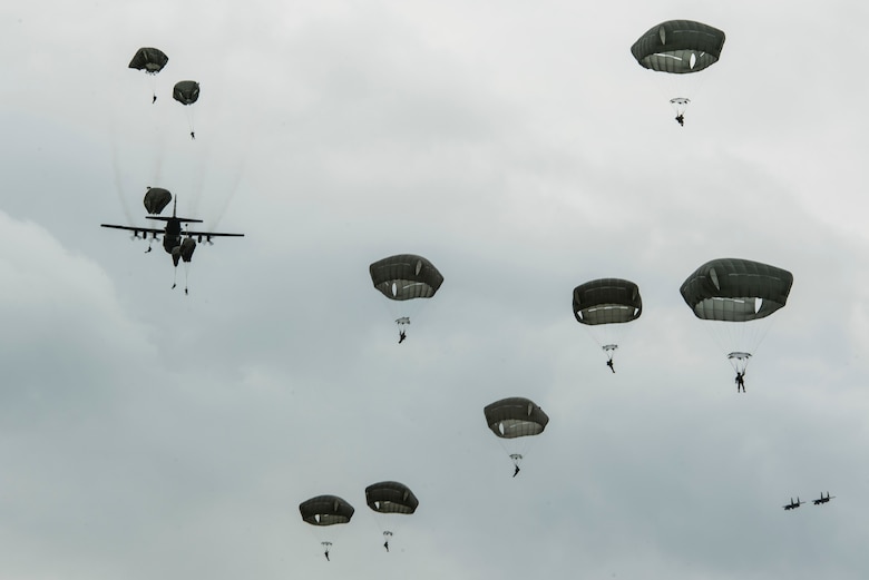 International Patatroopers participating in the D-Day Commemoration Airborne Operation fall into Iron Mike Drop Zone outside of Saint-Mere-Eglise, France June 9, 2019. Over 900 military paratroopers and 110 civilian parachutists from seven countries participated in the historic event. (U.S. Air Force photo by Senior Airman Devin M. Rumbaugh)