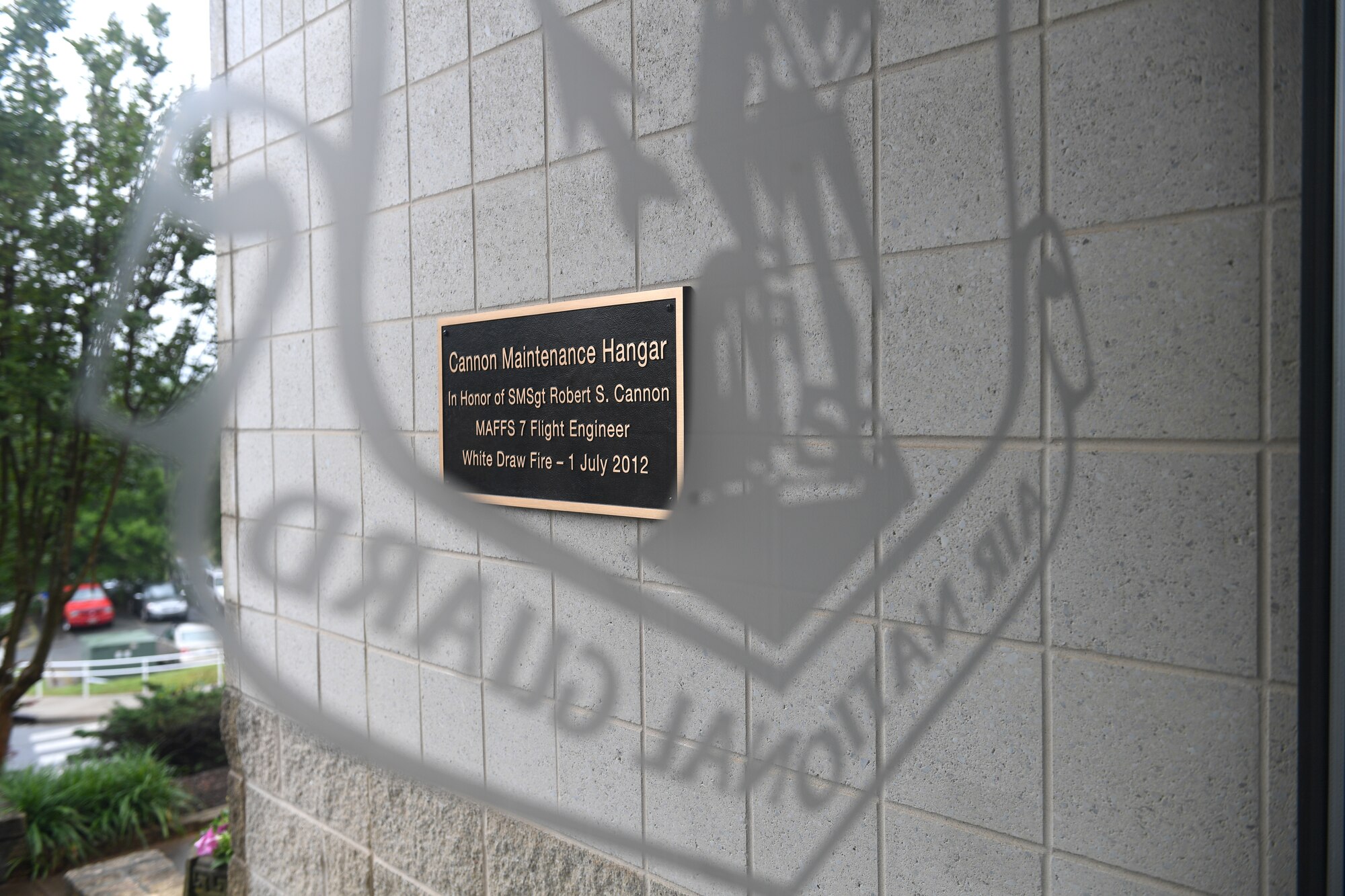 A plaque is displayed dedicating the 145th Maintenance Group hangar to U.S. Air Force Senior Master Sgt. Robert S. Cannon, a Modular Airborne Fire Fighting System (MAFFS) seven crew member, at the North Carolina Air National Guard Base, Charlotte Douglas International Airport, June 9, 2019. U.S. Air Force Lt. Col. Paul K. Mikeal, Maj. Joseph M. McCormick, Maj. Ryan S. David, and Senior Master Sgt. Robert S. Cannon tragically lost their lives seven years ago in the MAFFS seven accident while fighting fires in South Dakota. These Airmen were part of the MAFFS seven crew and are remembered with building dedication ceremonies to honor their legacy for years to come.