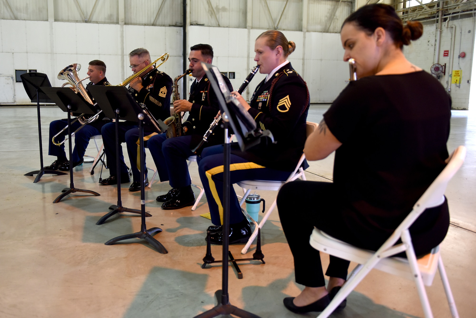 Members of the 440th Army Band practice in a hangar at the North Carolina Air National Guard Base, Charlotte Douglas International Airport, June 9, 2019 prior to the Building Dedication Ceremony to honor four fallen Airmen, U.S. Air Force Lt. Col. Paul K. Mikeal, Maj. Joseph M. McCormick, Maj. Ryan S. David, and Senior Master Sgt. Robert S. Cannon. The four Airmen tragically lost their lives seven years ago in the Modular Airborne Fire Fighting System (MAFFS) seven accident while fighting fires in South Dakota. These Airmen were part of the MAFFS seven crew and are remembered with building dedication ceremonies to honor their legacy for years to come.