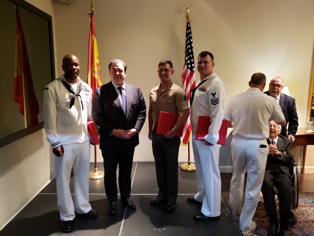 U.S. Marine Sgt. Jose Araya, an imagery analysis specialist, with Special Purpose Marine Air-Ground Task Force-Crisis Response-Africa 19.2, Marine Forces Europe and Africa, poses for a photo with Ambassador Duke Buchan III, United States Ambassador to Spain and Andorra, and other award recipients at the U.S. Embassy in Madrid, Spain, May 20, 2019.