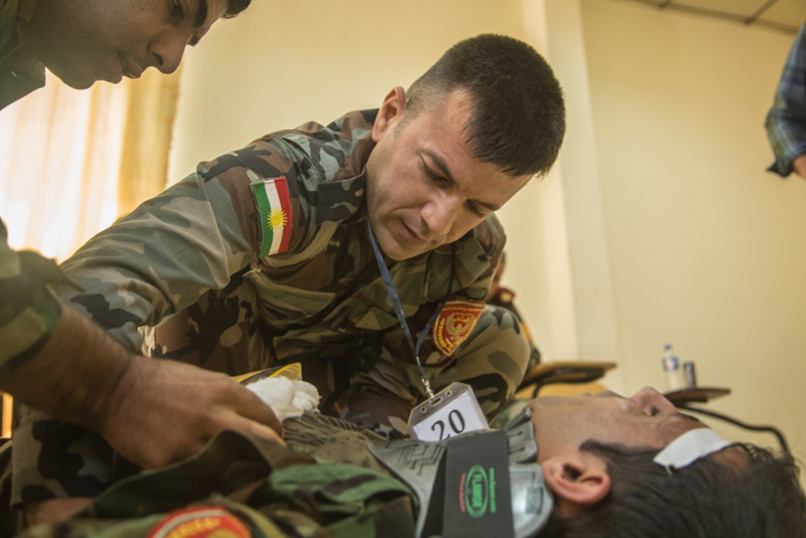 Peshmerga soldiers participate in a first aid medical exercise at the Bnaslawa Training Center near Erbil, Iraq, on May 22, 2019.  The exercise concluded a two-week intermediate combat life saver course for 21 Peshmerga soldiers under the direction of Italian Carabinieri instructors.  At the invitation of the Government of Iraq, members of the Global Coalition provide training and advice to local forces in support of the enduring mission to defeat Daesh. (U.S. Army photo by Spc. Kahlil Dash)