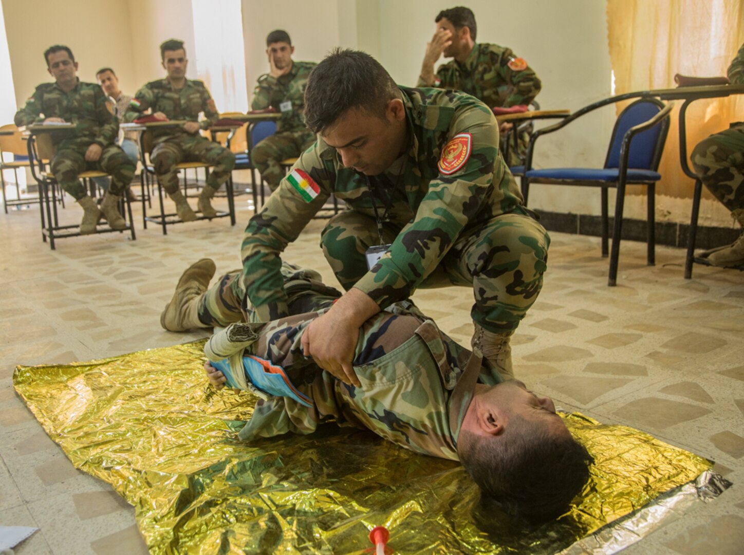 Peshmerga soldiers participate in a first aid medical exercise at the Bnaslawa Training Center near Erbil, Iraq, on May 22, 2019.  The exercise concluded a two-week intermediate combat life saver course for 21 Peshmerga soldiers under the direction of Italian Carabinieri instructors.  At the invitation of the Government of Iraq, members of the Global Coalition provide training and advice to local forces in support of the enduring mission to defeat Daesh. (U.S. Army photo by Spc. Kahlil Dash)