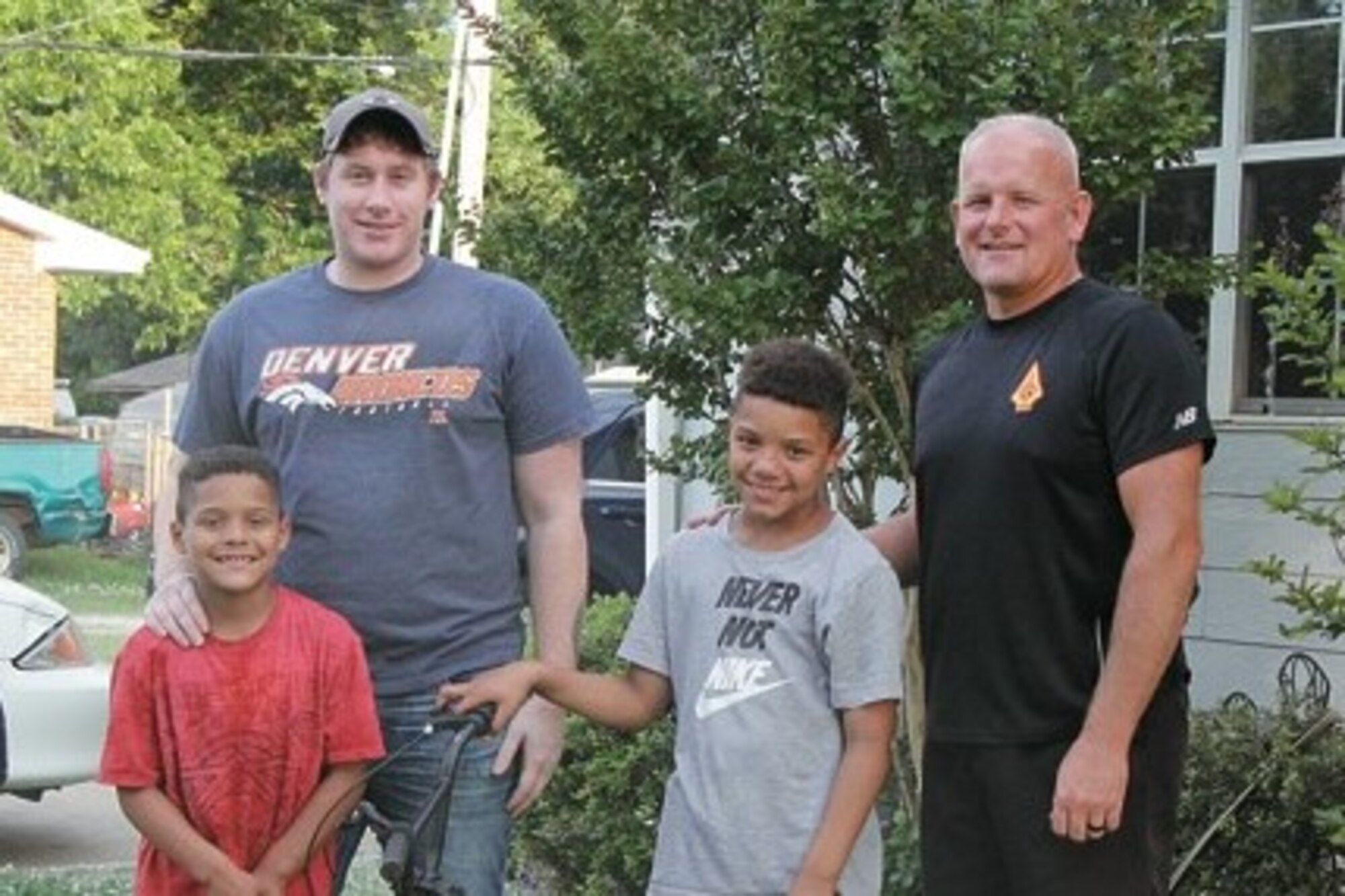 Torren Jackson (center) is pictured with rescuers that helped free him from swift running water May 29, 2019 when he was swept from the road while riding his bike and trapped inside a culvert in Prague, Oklahoma. From left: Teggan Jackson, Dakota Fite, Torren Jackson and Eric Whitesel. (Courtesy photo by Sharon Lee/Prague Times-Herald)