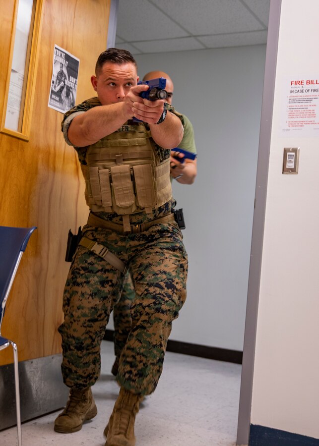 U.S. Marine Corps Cpl. Nicholas Muller, an administrative specialist with 4th Civil Affairs Group, Force Headquarters Group, breaches a room during a simulated active shooter exercise at Naval Operational Support Center & Marine Corps Reserve Center Miami, June 7, 2019. All 160 Marine Corps Reserve Training Centers are expected to exercise their active shooter emergency action plan semi-annually with their Inspector-Instructor staff and Reserve Marines. (U.S. Marine Corps photo by Lance Cpl. Jose Gonzalez)