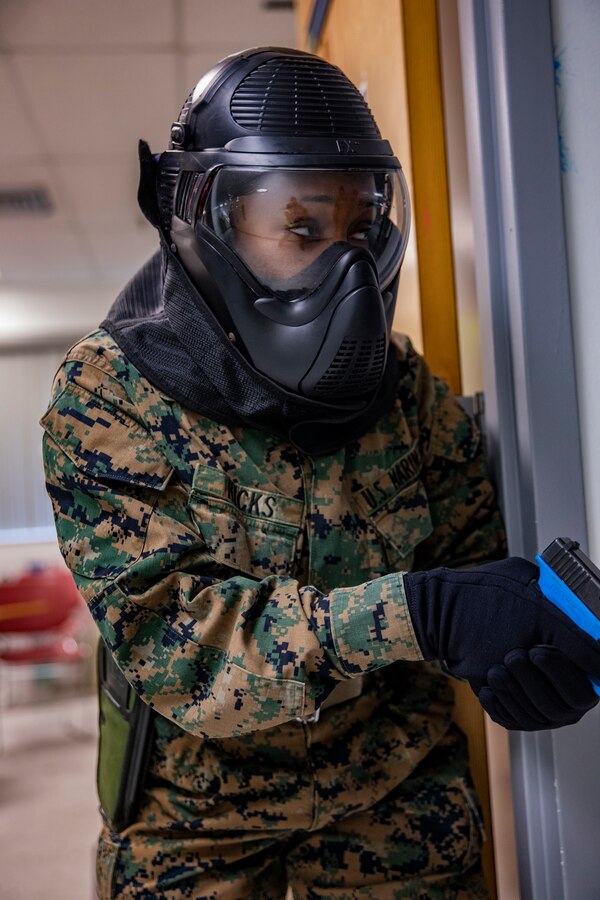 U.S. Marine Corps Cpl. Chelsie Hicks, an administrative clerk with 4th Civil Affairs Group, Force Headquarters Group, provides security during a simulated active shooter exercise at Naval Operational Support Center & Marine Corps Reserve Center Miami, June 8, 2019. All 160 Marine Corps Reserve Training Centers are expected to exercise their active shooter emergency action plan semi-annually with their Inspector-Instructor staff and Reserve Marines. (U.S. Marine Corps photo by Lance Cpl. Jose Gonzalez)