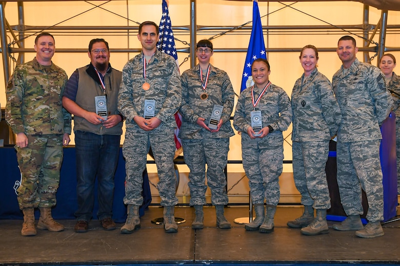 Maj. Gen. Jimmey R. Morrell Awards banquet award winners gather for a photo during the event in the Indoor Running Track at Schriever Air Force Base, Colorado, May 23, 2019. The event highlighted members of the 50th Operations Group who best epitomize the values and characteristics Morrell displayed during his career. (U.S. Air Force photo by Katheryn Calvert)