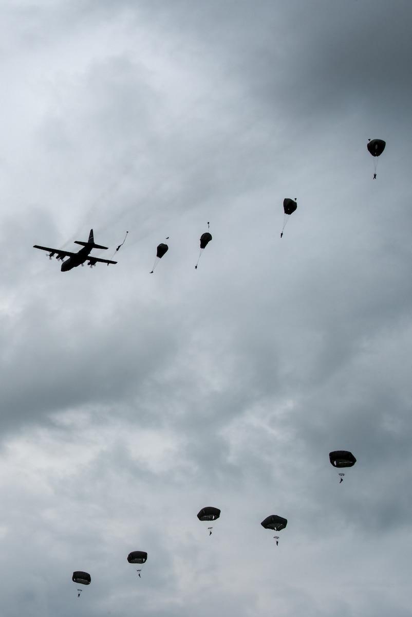Paratroopers jump from a Kentucky Air National Guard C-130 Hercules over the Iron Mike drop zone in Sainte-Mère-Église, France, June 9, 2019, as part of the 75th-anniversary commemoration of D-Day. The Commemorative Airborne Operations event included nearly 1,000 paratroopers from Belgium, France, Germany, The Netherlands, Poland, Romania and the United Kingdom; and members of U.S. Special Operations Command Europe, United States Army Civil Affairs and Psychological Operations Command, 18th Airborne Corps, 75th Ranger Regiment, 82nd Airborne Division, 173rd Airborne Brigade, 503rd Military Police Battalion, 509th Infantry Regiment, 4th Brigade Combat Team (Airborne), 25th Infantry Division, and U.S. Air Forces Europe. D-Day remains a historic reminder of how the dedicated resolve of allies with a common purpose and shared vision builds proven partnerships that endure. (U.S. Air National Guard photo by Phil Speck)