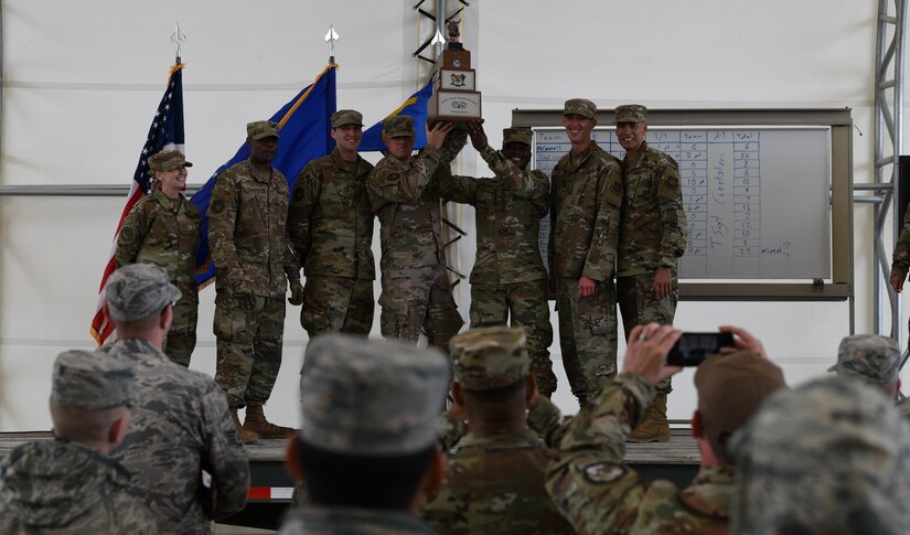 Vehicle operators from the 628th Logistics Readiness Squadron, hoist the 3rd Annual Ground Transportation Rodeo Trophy above their heads in triumph after winning the competition at Fort Leonard Wood, Mo., May 11, 2019.