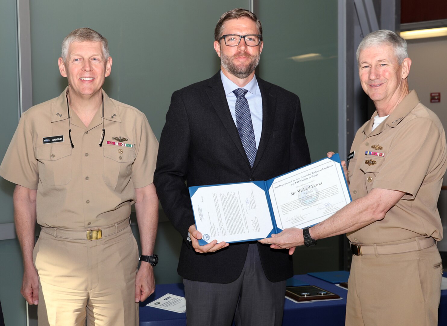 Vice Adm. Thomas Moore (right), commander, Naval Sea Systems Command, and Rear Adm. Lorin Selby, deputy commander for Ship Design, Integration and Engineering, present Michael Farrar, site director for Naval Surface Warfare Center, Carderock Division’s South Florida Ocean Measurement Facility (Code 754), the Department of Navy Award for Technical Excellence at a Test and Evaluation Facility or Range during a ceremony at the Washington Navy Yard on May 29, 2019. (U.S. Navy photo by Laura Lakeway/Released)