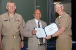 Vice Adm. Thomas Moore (right), commander, Naval Sea Systems Command, and Rear Adm. Lorin Selby, deputy commander for Ship Design, Integration and Engineering, present Timothy Cullis, an electrical engineer in Naval Surface Warfare Center, Carderock Division’s Signatures Monitoring and Surface Ships Programs Branch, the Department of Navy Small Program Outstanding Tester Award during a ceremony at the Washington Navy Yard on May 29, 2019. (U.S. Navy photo by Laura Lakeway/Released)