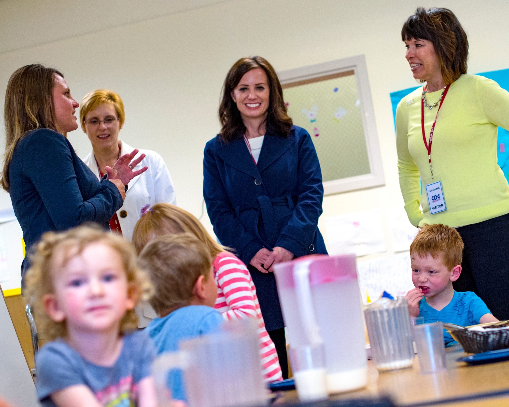 (From right to left) Kelly Barrett, 18th Air Force commander spouse, Kris Salmi, 92nd Air Refueling Wing commander spouse, and Mary Heathman, 92nd ARW vice commander spouse, visit with a Child Development Center class at Fairchild Air Force Base, Washington, May 21, 2019. Barrett toured the CDC and other family quality-of-life providers throughout her visit. (U.S. Air Force photo by Airman 1st Class Whitney Laine)