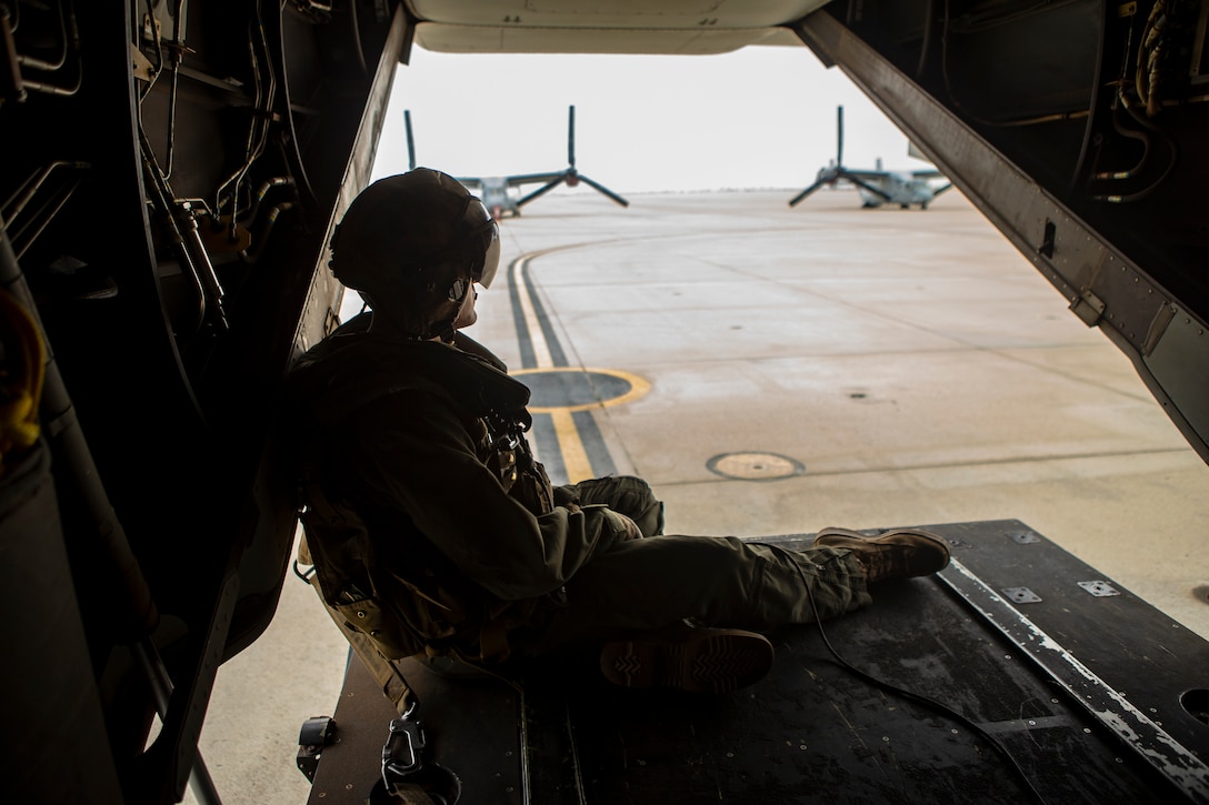 A U.S. Marine crew chief with Marine Aircraft Group (MAG) 16, 3rd Marine Aircraft Wing (MAW), observes his surroundings during MAG-16’s mass flight exercise at Marine Corps Air Station (MCAS) Miramar, Calif., June 6, 2019. 3rd MAW Marines’ invaluable contributions to the operational excellence of equipment and aircraft made MAG-16’s mass launch ensure the units remain trained and ready to serve as an integral component of the Marine Air-Ground Task Force (MAGTF) by providing the aviation combat element for I Marine Expeditionary Force – the Marine Corps’ largest MAGTF. (U.S. Marine Corps photo by Lance Cpl. Cheng Chang)