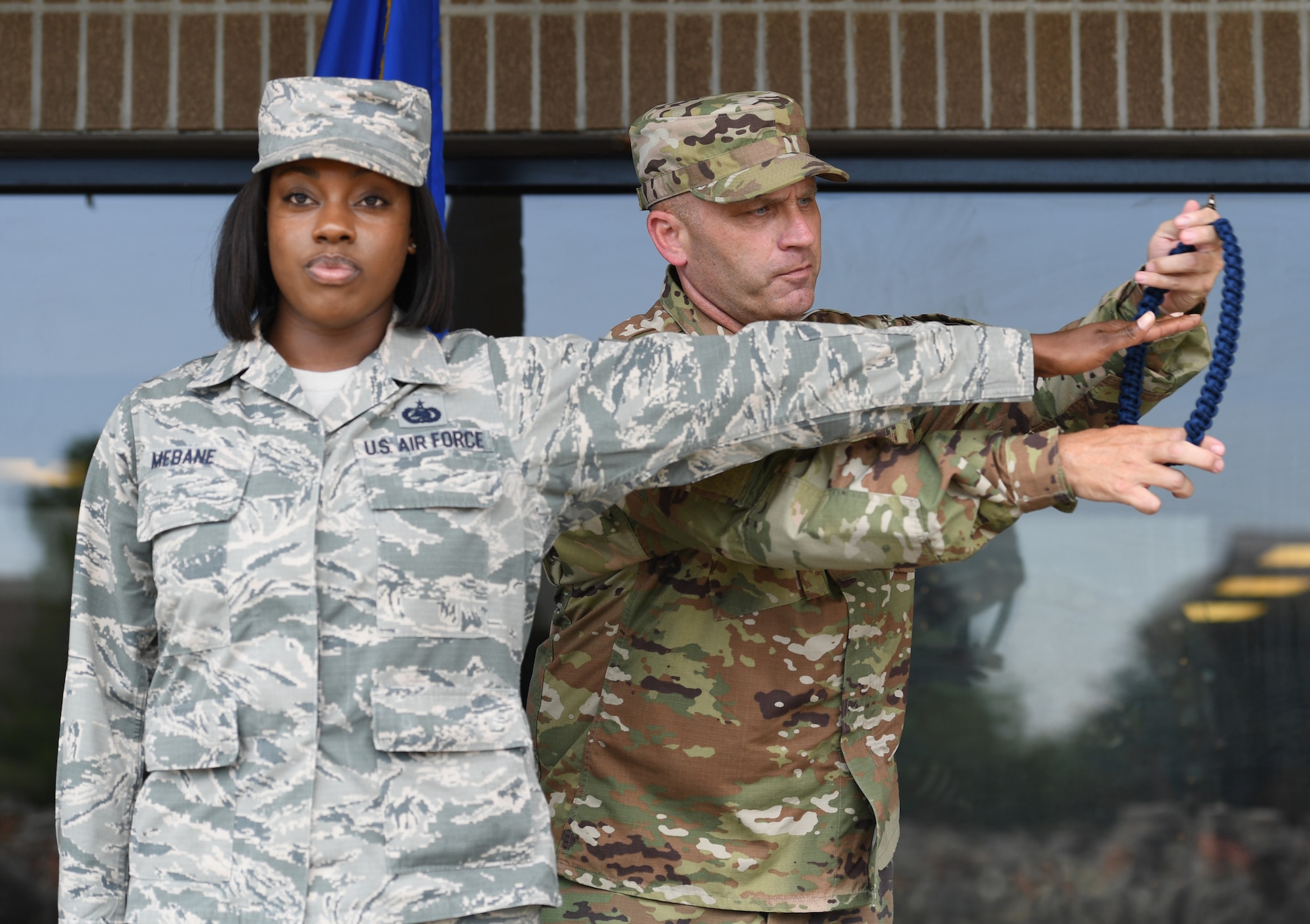 U.S. Air Force Chief Master Sgt. Anthony Fisher, 81st Training Group superintendent, presents a blue rope to Staff Sgt. Allison Mebane, 81st Training Support Squadron military training leader course student, during a MTL course graduation ceremony at the Levitow Training Support Facility on Keesler Air Force Base, Mississippi, May 30, 2019. The MTL course is responsible for training approximately 120 MTLs per year. Those MTLs are then responsible for training approximately 30,000 Airmen in 49 different locations that fall under Air Education and Training Command. (U.S. Air Force photo by Kemberly Groue)