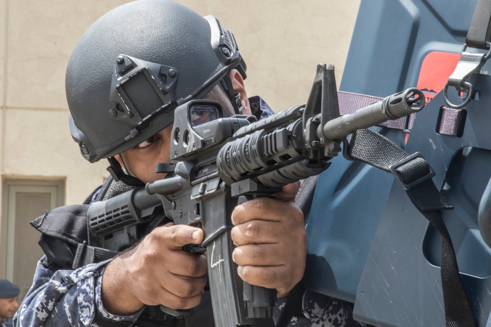 A Kuwait Special Forces Soldier uses the corner of a tactical vehicle for cover while pulling security on May 2, 2019 during a joint exercise with a simulated terrorist, explosive ordnance, and chemical situation at the Kuwait Special Forces Training Center. The exercise was crafted to build a shared understanding of Kuwait Civil Authorities and U.S. Forces procedures while reacting to any disaster, natural and manmade alike.
