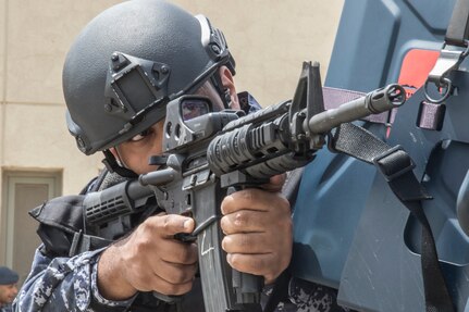 A Kuwait Special Forces Soldier uses the corner of a tactical vehicle for cover while pulling security on May 2, 2019 during a joint exercise with a simulated terrorist, explosive ordnance, and chemical situation at the Kuwait Special Forces Training Center. The exercise was crafted to build a shared understanding of Kuwait Civil Authorities and U.S. Forces procedures while reacting to any disaster, natural and manmade alike.