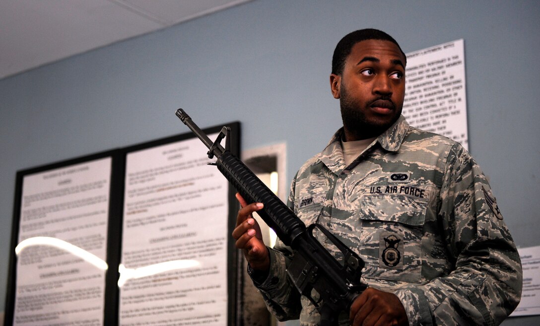 Senior Airman Darian Brown, 439th Security Forces Squadron patrolman, demonstrates how to clear the barrel of an M16 rifle, at Westover Air Reserve Base, Mass. June 8, 2019. The 439th SFS launched their new weapons simulation training program to help ensure trainees in the Development and Training Flight are ready for Basic Military Training. (U.S. Air Force photo by Staff. Sgt. Tamara Williams/released)