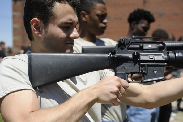 Victor Shanwenda, a member of the Development and Training Flight looks down the aiming sights of an M16 rifle, at Westover Air Reserve Base, Mass. June 8, 2019. The 439th Security Forces Squadron trained DTF members on M16s in order to familiarize them with the weapon they will qualify on during Basic Military Training. (U.S. Air Force photo by Staff Sgt. Tamara Williams/released)