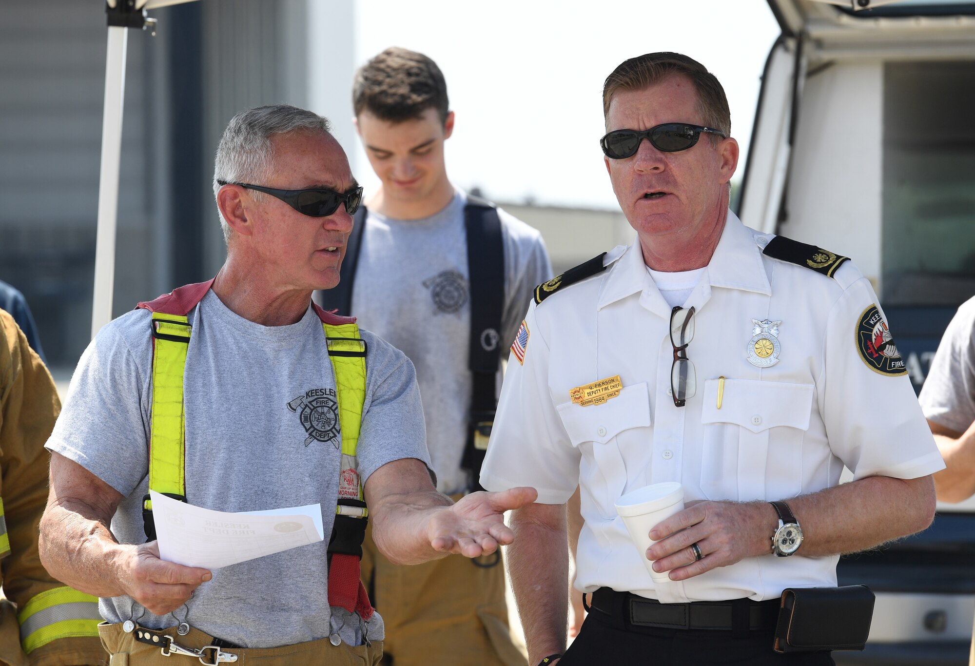 Rusty Bell, 81st Infrastructure Division firefighter, and Gary Pierson, 81st ID deputy fire chief, discuss approaching procedures during an aircraft rescue fire fighting training on Keesler Air Force Base, Mississippi, June 4, 2019. The joint agency training allowed the Keesler Fire Department, Gulfport Combat Readiness Training Center Fire Department, Stennis Airport Fire Department and the U.S. Naval Air Station Pensacola Gulf Coast Fire Rescue to meet the semi-annual training requirement to practice aircraft rescue and live fire training evolutions. (U.S. Air Force photo by Kemberly Groue)