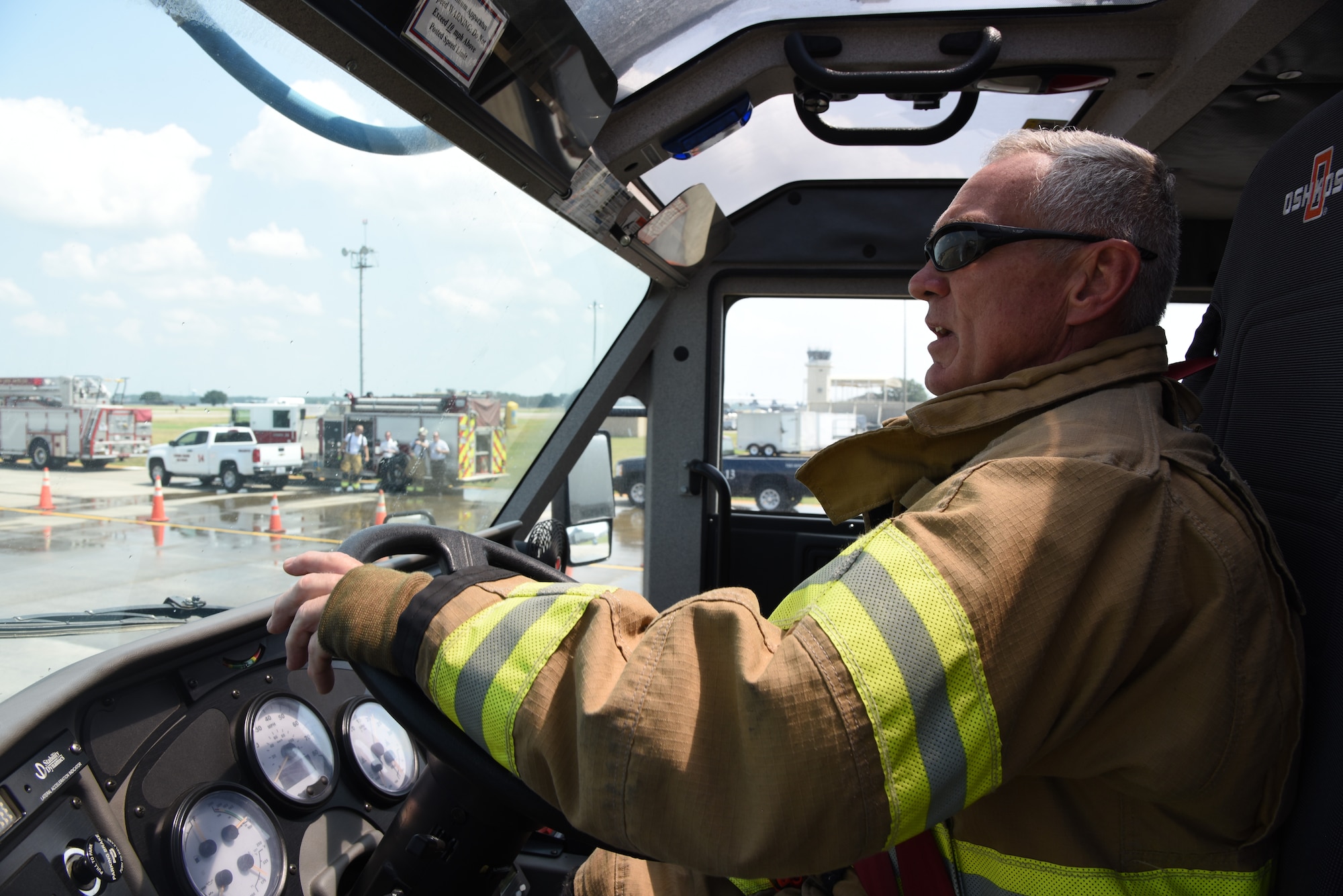 Rusty Bell, 81st Infrastructure Division firefighter, operates a fire truck to extinguish a fire on a mock C-123 training device during an aircraft rescue fire fighting training on Keesler Air Force Base, Mississippi, June 4, 2019. The joint agency training allowed the Keesler Fire Department, Gulfport Combat Readiness Training Center Fire Department, Stennis Airport Fire Department and the U.S. Naval Air Station Pensacola Gulf Coast Fire Rescue to meet the semi-annual training requirement to practice aircraft rescue and live fire training evolutions. (U.S. Air Force photo by Kemberly Groue)
