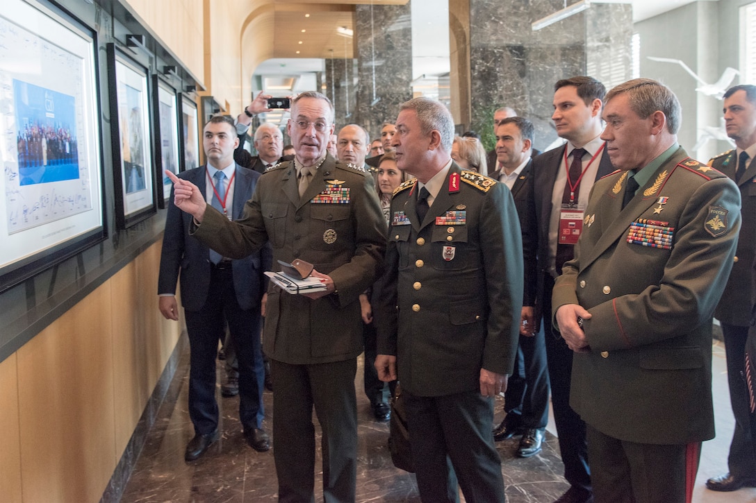 Marine Corps Gen. Joe Dunford, the chairman of the Joint Chiefs of Staff, speaks to defense leaders as others follow them.