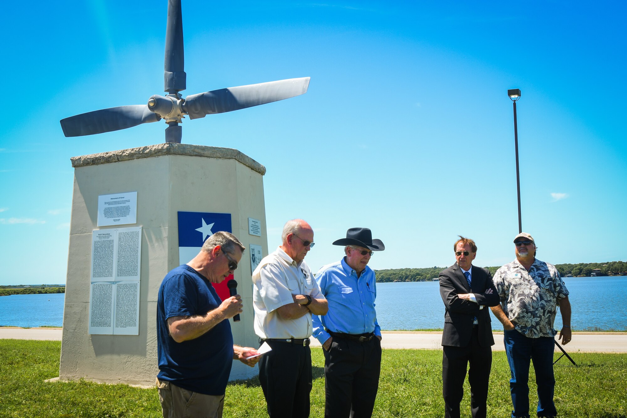 People stand in front of dedicated monument