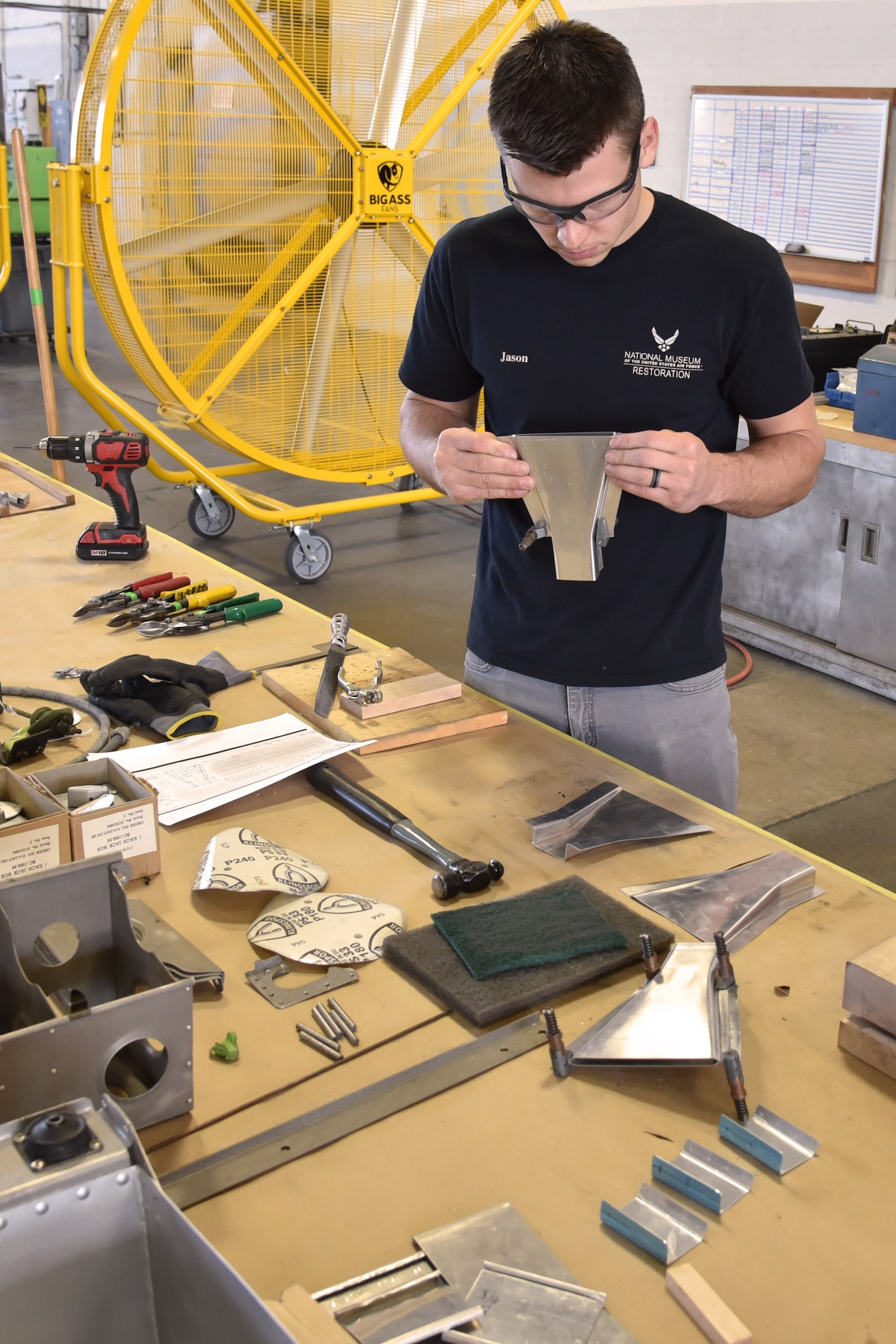 DAYTON, Ohio -- Museum restoration specialist Jason Davis works on the heater for the nose section of the Boeing B-17F Memphis Belle at the National Museum of the U.S. Air Force on June 3, 2019. (U.S. Air Force photo by Ken LaRock)