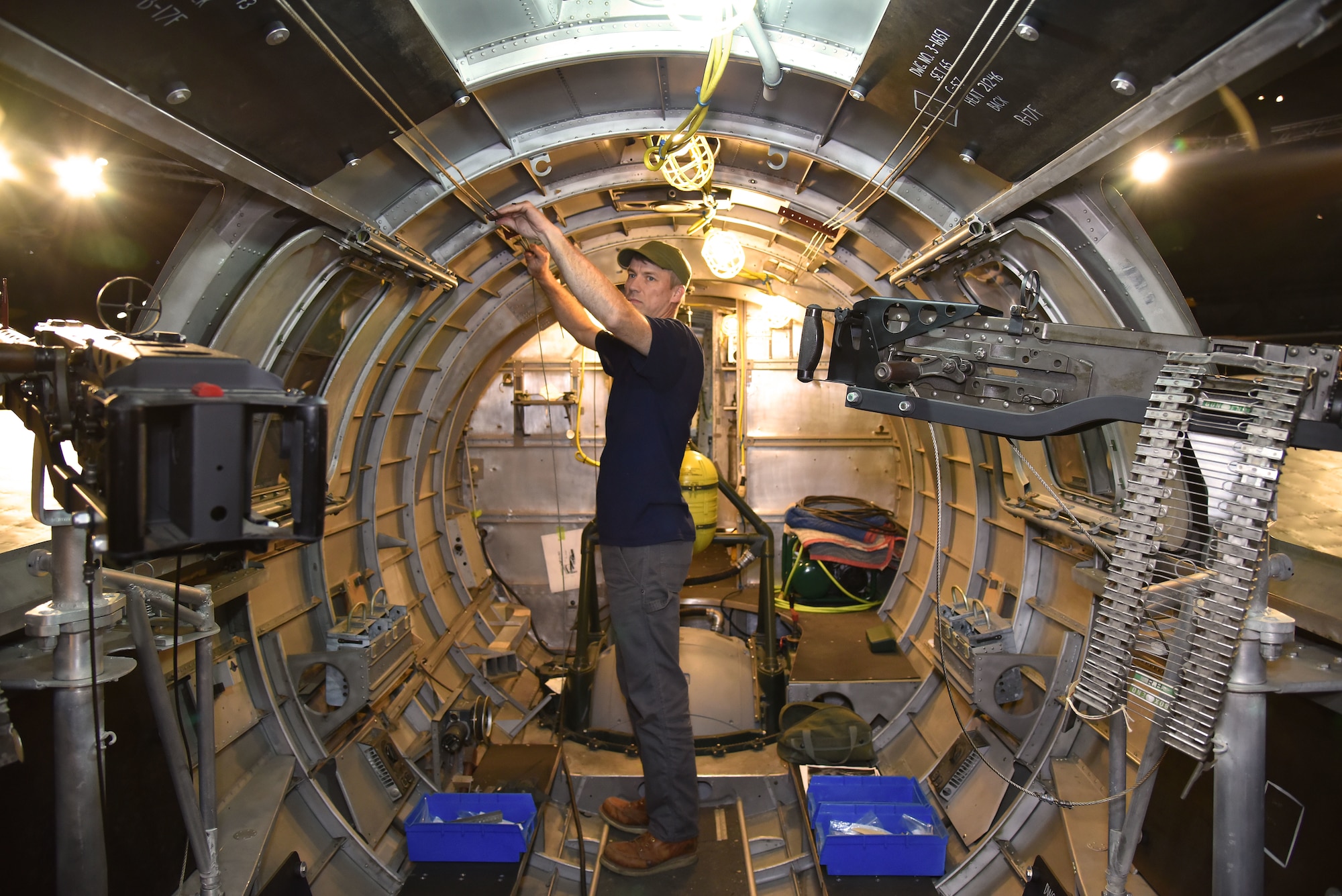 DAYTON, Ohio -- Museum restoration specialist Chad Vanhook works on the waist gun section of the Boeing B-17F Memphis Belle at the National Museum of the U.S. Air Force on June 3, 2019. (U.S. Air Force photo by Ken LaRock)