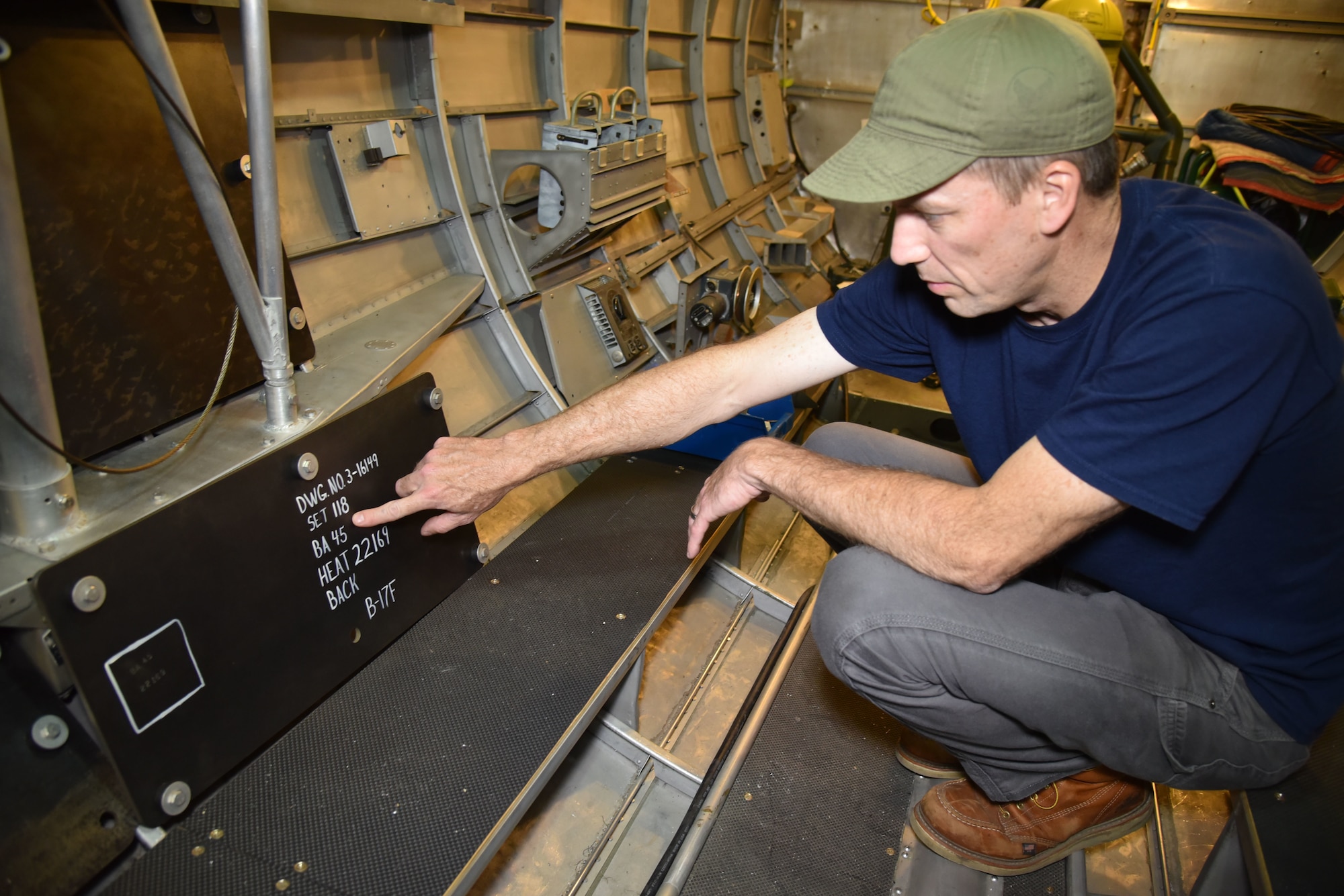 DAYTON, Ohio -- Museum restoration specialist Chad Vanhook views the armor plating of the left waist gun position on the Boeing B-17F Memphis Belle at the National Museum of the U.S. Air Force on June 3, 2019. (U.S. Air Force photo by Ken LaRock)