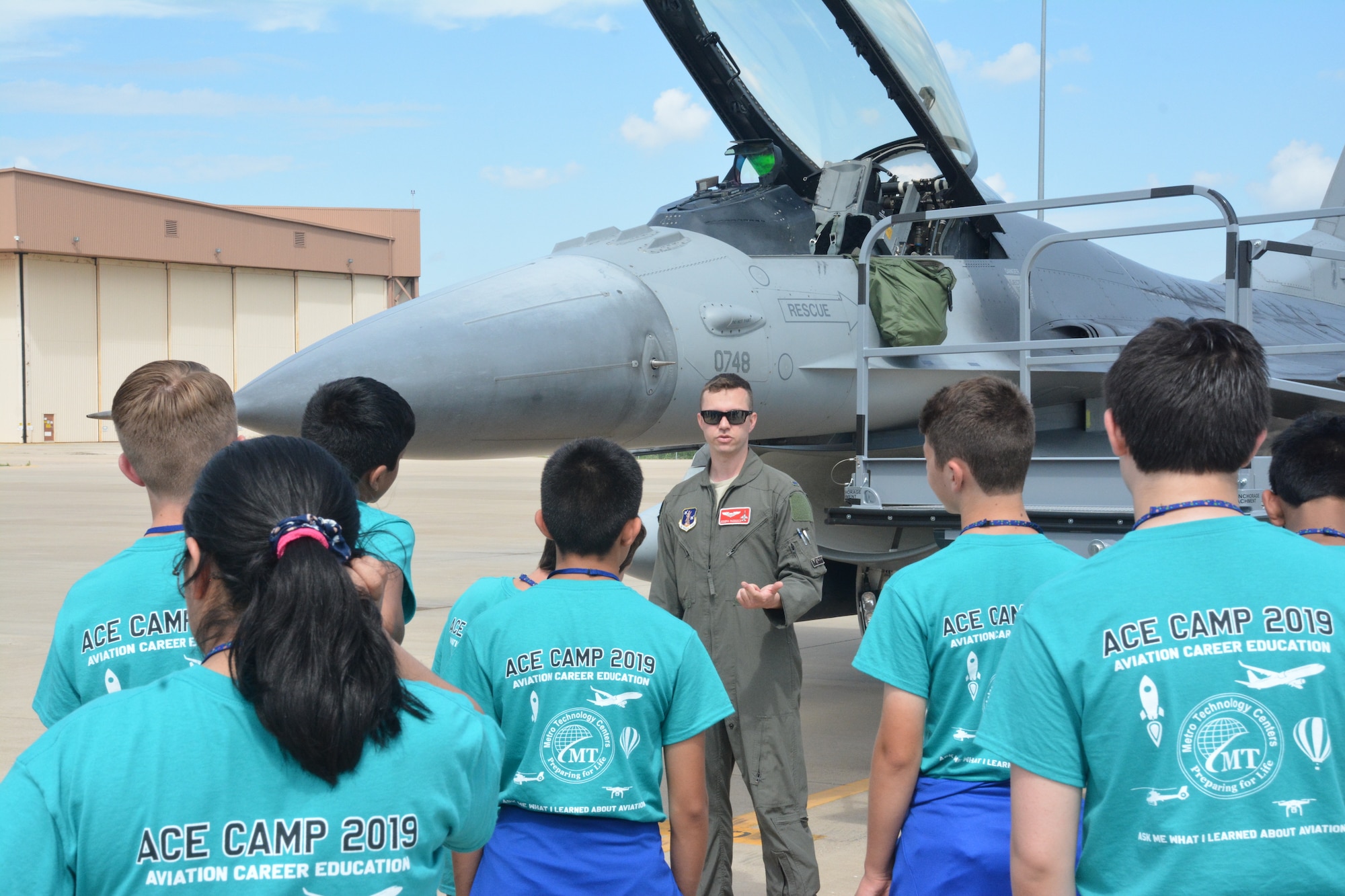 A pilot from the Oklahoma Air National Guard's 138th Fighter Wing briefs students on the capabilities of the F-16 Fighting Falcon. The 2019 Aviation Career Education, or ACE academy provides middle and high school kids weeklong immersion experiences in a variety of aviation and aerospace professions. The Oklahoma City ACE toured with the 507th ARW on June 5, 2019 at Tinker Air Force Base, Oklahoma. (U.S. Air Force Photo by Maj. Jon Quinlan)