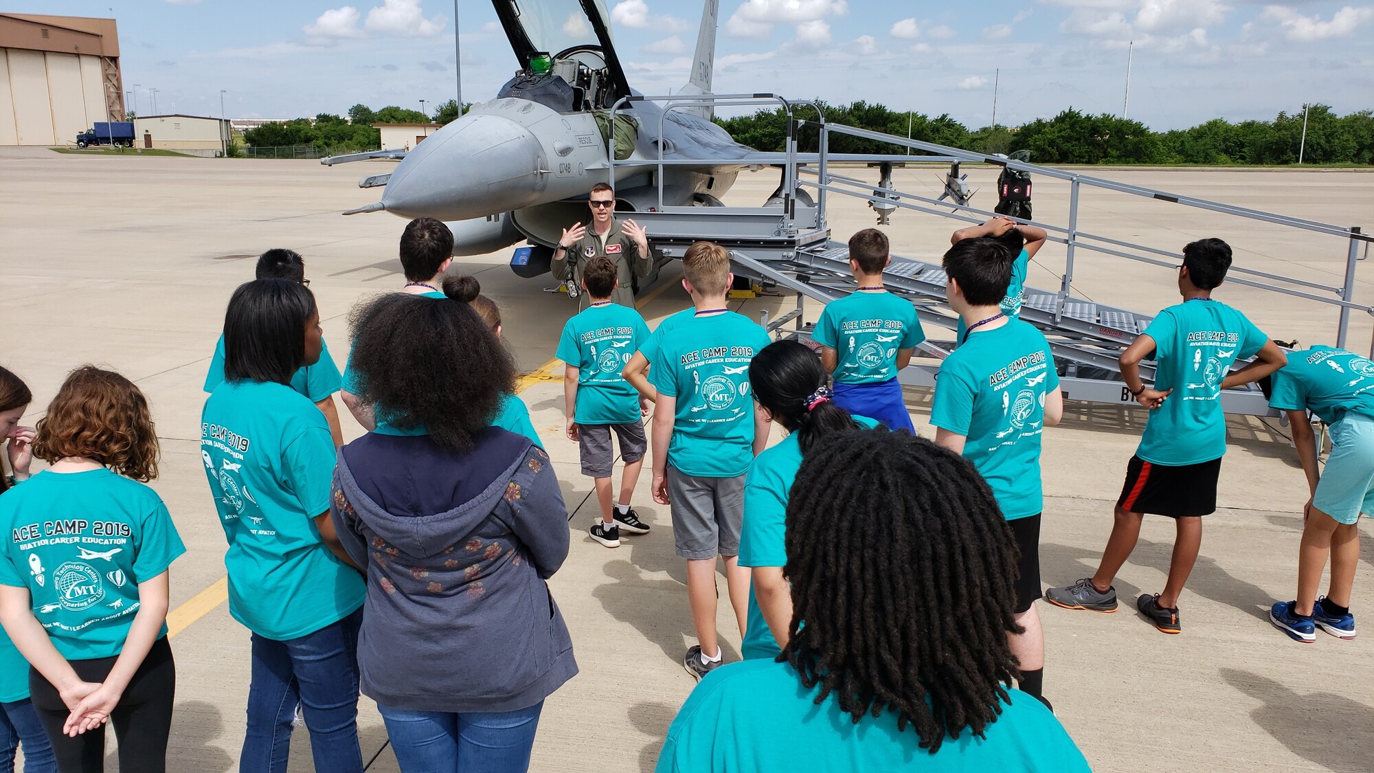 Pilots from the Oklahoma Air National Guard's 138th Fighter Wing brief students on the capabilities of the F-16 Fighting Falcon. The 2019 Aviation Career Education, or ACE academy provides middle and high school kids weeklong immersion experiences in a variety of aviation and aerospace professions. The Oklahoma City ACE toured with the 507th ARW on June 5, 2019 at Tinker Air Force Base, Oklahoma. The students received hands-on briefings and tours from pilots operating the KC-135R Stratotanker, F-16 Fighting Falcon and the T-6 Texan II aircraft. (U.S. Air Force Photo by Maj. Jon Quinlan)