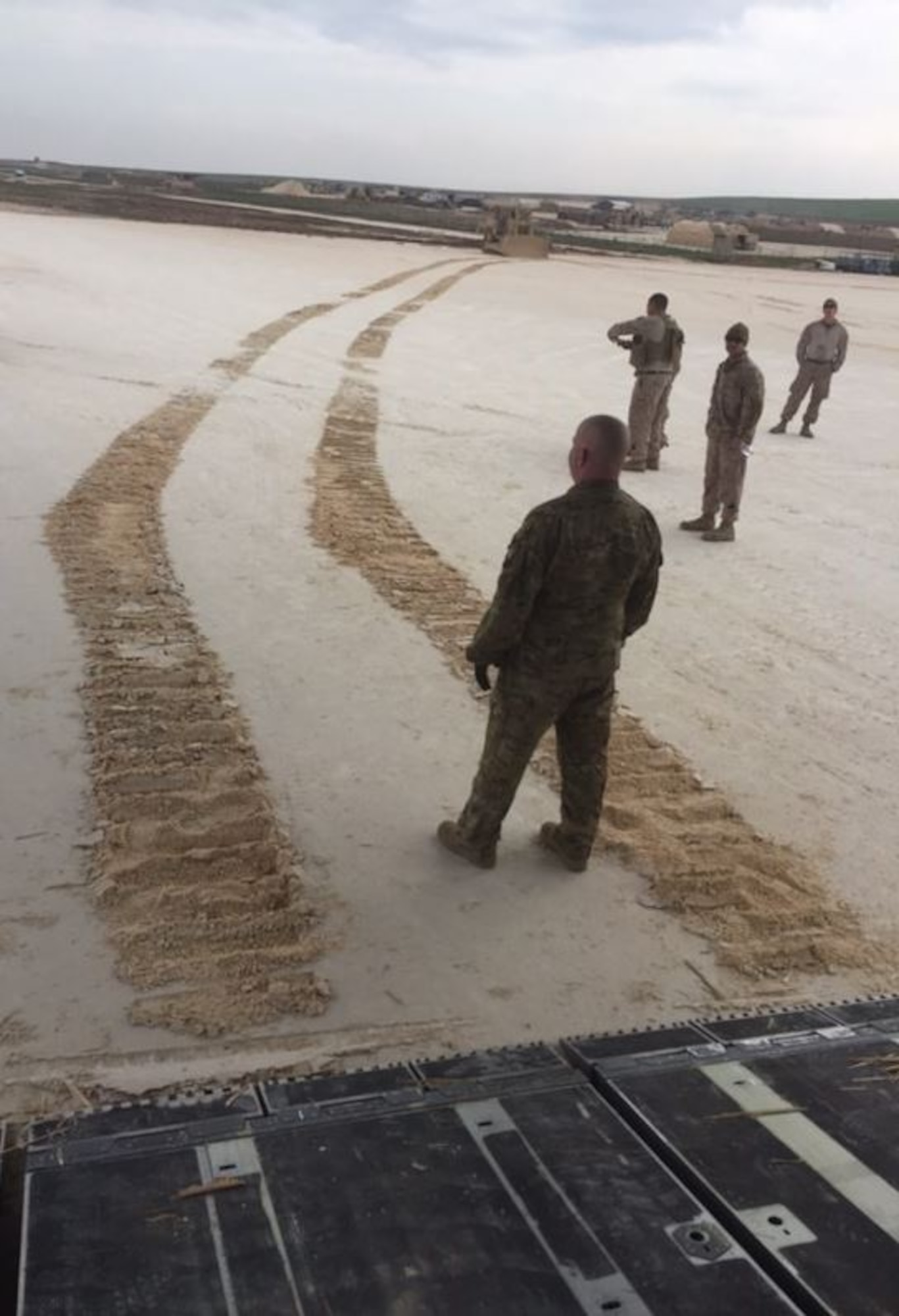 U.S. military members work alongside host nation forces ensuring safe airfield operations in a dirt runway in Syria, March 2019. Their mission consisted of day and night operations to train military members to perform dirt runway inspection, communicating with aircraft in flight, reporting and forecasting weather conditions, marshalling aircraft, and setting up mission-specific dirt runway lights.
 (U.S. Air Force photo by Maj. Thomas Weber)