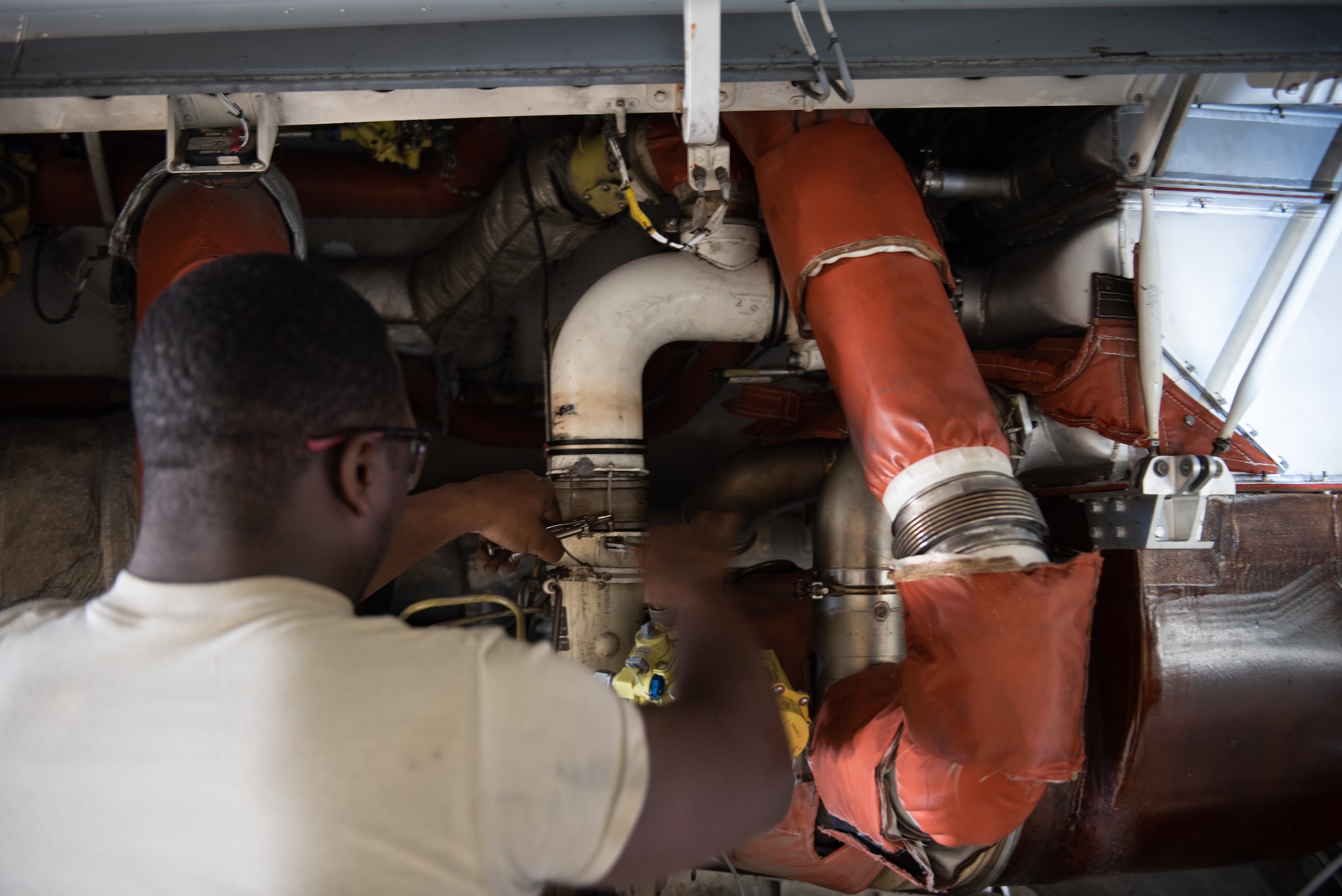 U.S. Air Force Airman 1st Class Leonard Howell, 62nd Maintenance Squadron electrical environmental apprentice, performs maintenance on the cooling system of a C-17 Globemaster III June 3, 2019, at Travis Air Force Base, California. Airmen from Joint Base Lewis-McChord, Washington, and Travis have completed 18 C-17 inspections since February. (U.S. Air Force photo by Tech. Sgt. James Hodgman)