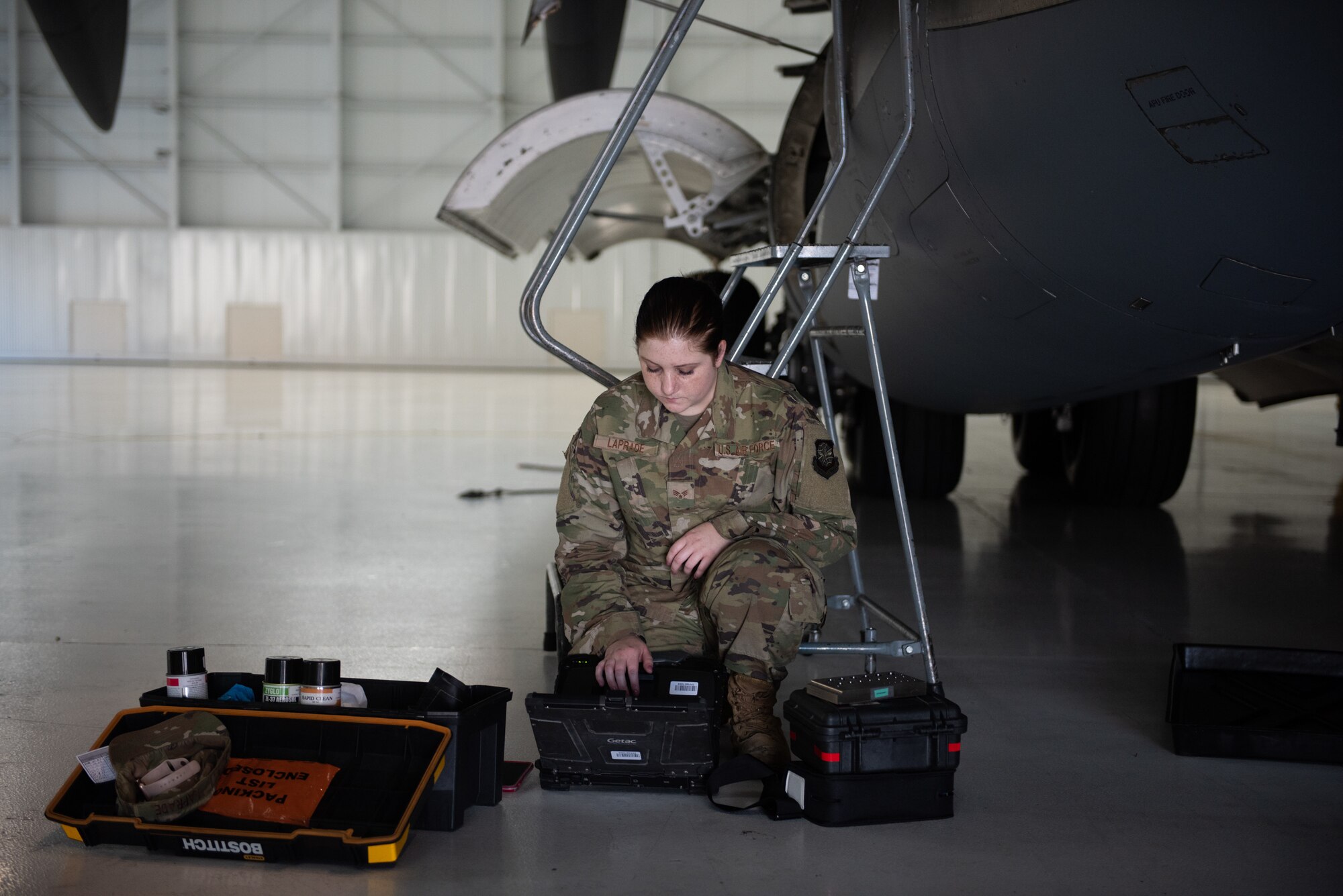 U.S. Air Force Senior Airman Kayla Laprade, 62nd Maintenance Squadron nondestructive inspection journeyman, reviews technical orders June 3, 2019, at Travis Air Force Base, California, prior to the inspection of the ram air inlet of a C-17 Globemaster III assigned to Joint Base Lewis-McChord, Washington. In February, JBLM sent its entire C-17 fleet to Travis to complete required maintenance and inspections. (U.S. Air Force photo by Tech. Sgt. James Hodgman)