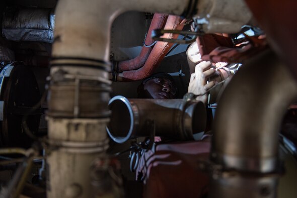 U.S. Air Force Airman 1st Class Leonard Howell, 62nd Maintenance Squadron electrical environmental apprentice, performs maintenance on the cooling system of a C-17 Globemaster III June 3, 2019, at Travis Air Force Base, California. Airmen from Joint Base Lewis-McChord, Washington, and Travis have completed 18 C-17 inspections since February. (U.S. Air Force photo by Tech. Sgt. James Hodgman)