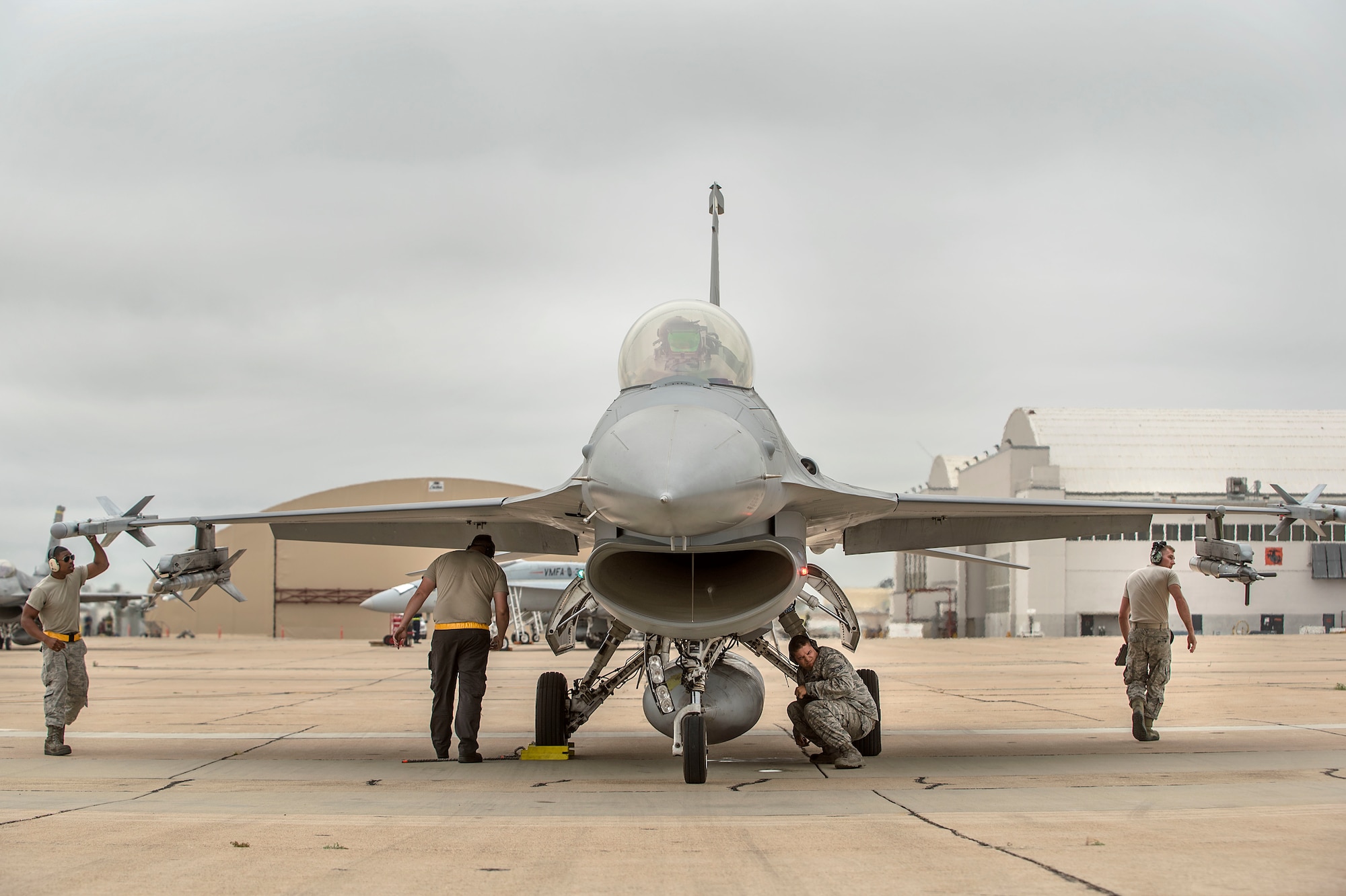 Airmen from the 314th Aircraft Maintenance Unit ensure weapons are loaded to a 314th Fighter Squadron F-16 VIper, prior to take off June 4, 2019, on Marine Corps Air Station Miramar, Calif. The 314th FS F-16 pilots conducted dissimiliar combat air training alongside F/A-18 Hornets from the Marine Fighter Attack Squadron 314. (U.S. Air Force photo by Staff Sgt. Christine Groening)