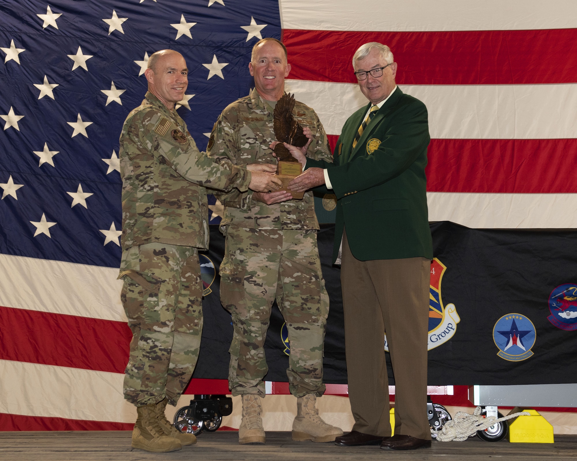 Brig. Gen. Todd Canterbury, 56th Fighter Wing commander (center), receives the 2018 Clements McMullen Memorial Maintenance Daedalian Trophy during a ceremony at Luke Air Force Base, Ariz., May 30, 2019. Awarded annually by the Secretary of the Air Force, the award is presented to the Air Force unit with the greatest weapon system maintenance record for the prior year. The 56th FW, led by its more than 3,334 maintenance personnel.