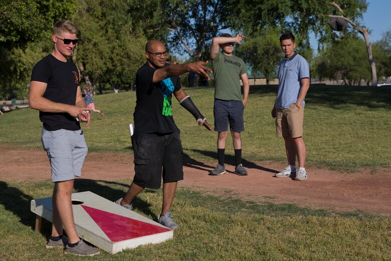 U.S. Marines and Sailors assigned to Headquarters and Headquarters Squadron (H&HS) race towards the finish line during the H&HS Family Day cardboard boat race at West Wetlands Park Yuma Ariz., April 18, 2019. (U.S. Marine Corps photo by Lance Cpl. Joel Soriano)