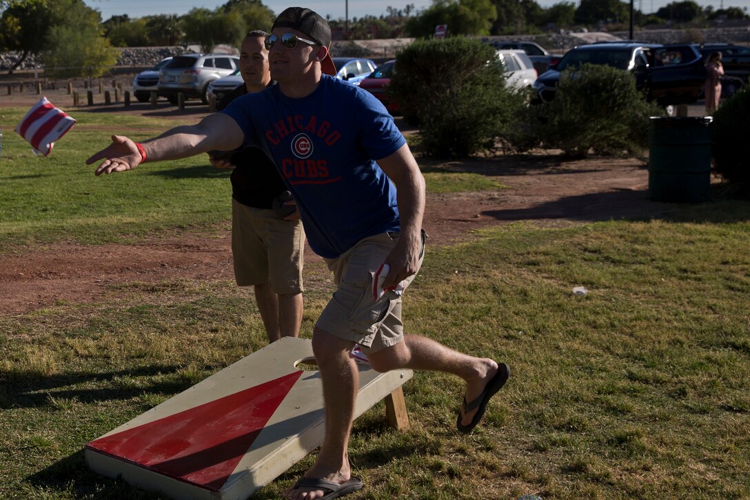 U.S. Marines and Sailors assigned to Headquarters and Headquarters Squadron (H&HS) race towards the finish line during the H&HS Family Day cardboard boat race at West Wetlands Park Yuma Ariz., April 18, 2019. (U.S. Marine Corps photo by Lance Cpl. Joel Soriano)
