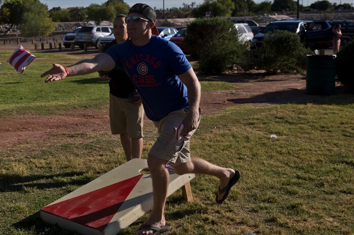 U.S. Marines and Sailors assigned to Headquarters and Headquarters Squadron (H&HS) race towards the finish line during the H&HS Family Day cardboard boat race at West Wetlands Park Yuma Ariz., April 18, 2019. (U.S. Marine Corps photo by Lance Cpl. Joel Soriano)