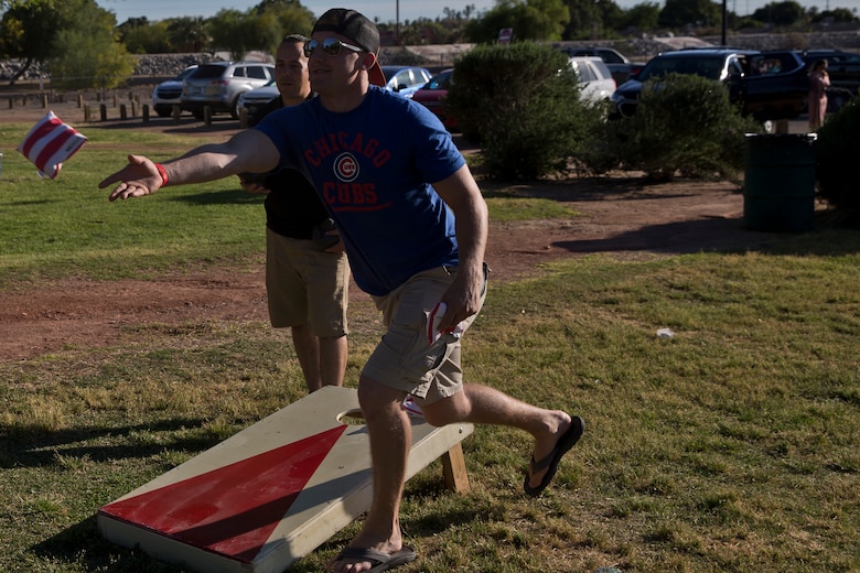 U.S. Marines and Sailors assigned to Headquarters and Headquarters Squadron (H&HS) race towards the finish line during the H&HS Family Day cardboard boat race at West Wetlands Park Yuma Ariz., April 18, 2019. (U.S. Marine Corps photo by Lance Cpl. Joel Soriano)