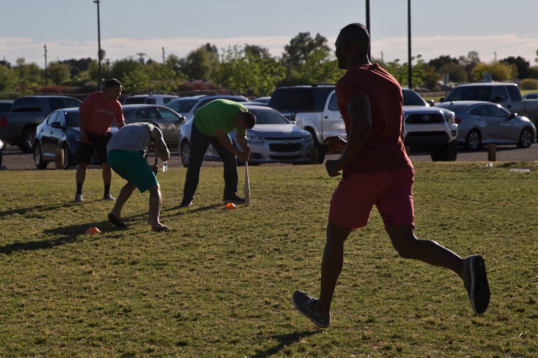 U.S. Marines and Sailors assigned to Headquarters and Headquarters Squadron (H&HS) race towards the finish line during the H&HS Family Day cardboard boat race at West Wetlands Park Yuma Ariz., April 18, 2019. (U.S. Marine Corps photo by Lance Cpl. Joel Soriano)