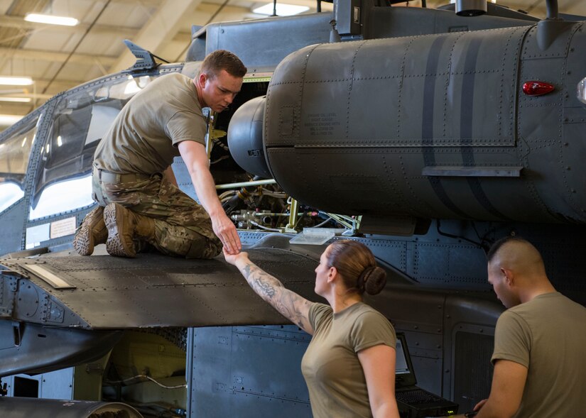 U.S. Army Advanced Individual Training students assigned to the 222nd Aviation Regiment, 1st Aviation Battalion, 128th Aviation Brigade assist each other during an AH-64 Armament/Electrical/Avionic Systems Repairer course at Joint Base Langley-Eustis, Virginia, June 10, 2019.